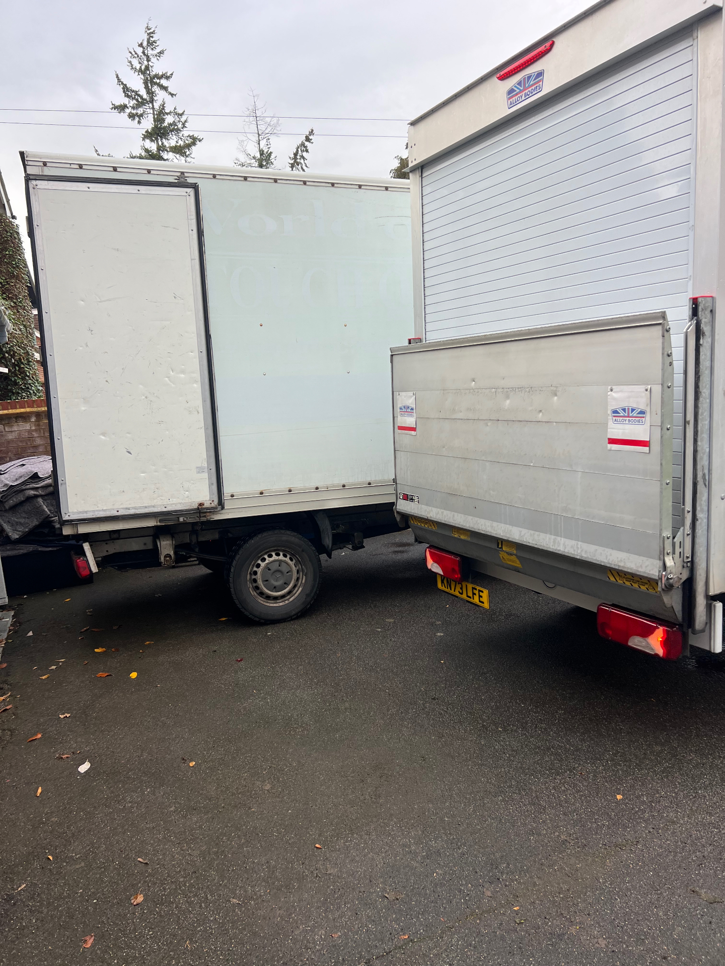 Two Luton removal vans parked back-to-back at a UK house move